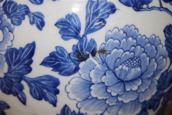 A Chinese blue and white painted lidded baluster vase, painted with blossoming peonies height 45cm, cracked